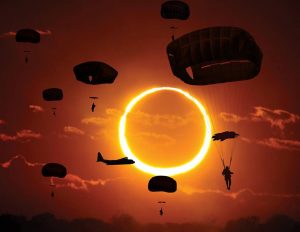 Airborne Systems T-11 Static Line Advanced Tactical Troop Parachute non-steerable for military jumpers. Carries an all-up weight of 400 lbs. Max deployment altitude of 7500 ft. 7 paratroopers and aircraft with beautiful maroon sky and total solar eclipse.