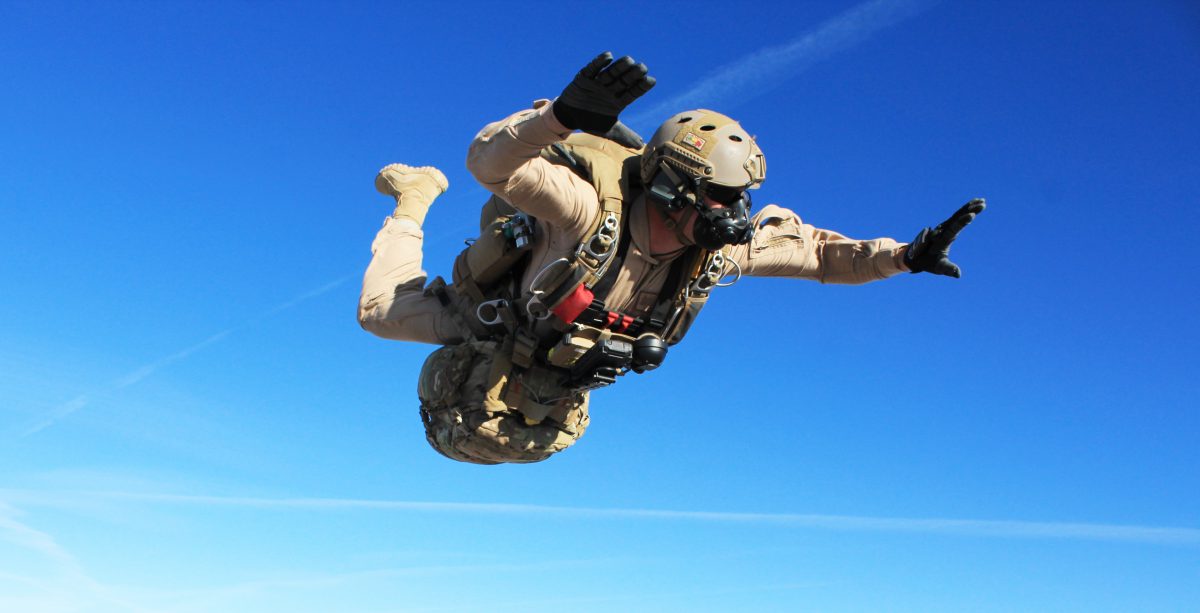 Airborne Systems - Parachute Oxygen Systems for Military - SOLR™ Airborne Systems jTrax Navaid Parachute Navigation System for army and military jumpers and JPADS and GPADS cargo guided precision aerial delivery systems. Army jumper freefall SOLR mask, Navaid, blue sky.