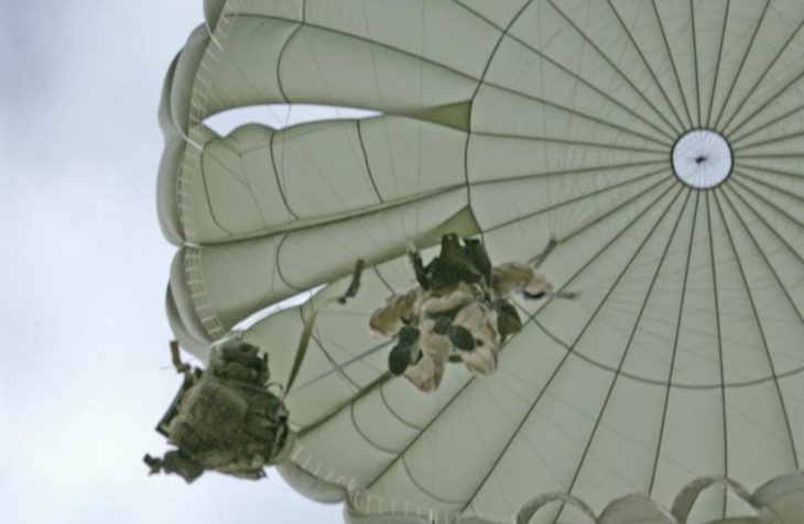 Airborne Systems MC-6 Army Troop Parachute non-steerable for military jumpers. Low opening. Carries up to 400 lbs. Minimum deployment altitude 500 ft. Canopy and jumper from below.