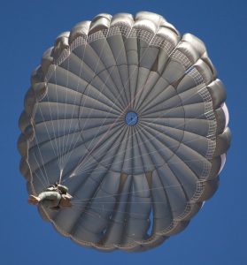 Airborne Systems MC-6 Army Troop Parachute non-steerable for military jumpers. Low opening. Carries up to 400 lbs. Minimum deployment altitude 500 ft. Canopy and jumper from below.