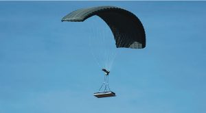 Airborne Systems DragonFly Army Cargo Delivery Parachute System flying with cargo. JPADS 10K System of Choice. Eliptical canopy carries loads up to 10,000 lbs. Max altitude 24,500 ft.