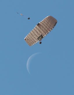 Airborne Systems FireFly Army Cargo Delivery Parachute System. JPADS 2K System of Choice. Carries unmanned loads up to 2,200 lbs. Max deployment altitude 24,500 ft. drop from below. Waxing / crescent moon.