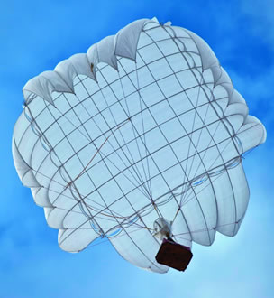 Airborne Systems Unicross Army cargo delivery parachute system. Low cost, modular design for one-time use or quick repack. Three sizes carry payloads of 75 lbs to 3,200 lbs. Cargo drop white canopy from below, blue sky. Military & space textile manufacturing & design. Army & space parachute canopies, aerial delivery (GPADS/JPADS). Aircraft & spacecraft deceleration systems.
