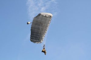 Airborne Systems - Intruder RA-1 Army Ram Air Parachute system for military special forces and beginner jumpers. Carries 450 lbs. Max deployment altitude 25,000 ft. Jumper and blue sky. Fort Bragg 2016.