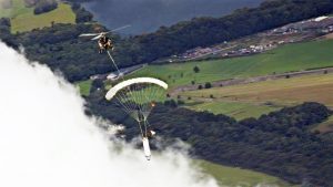 Airborne Systems. Payload recovery with helicopter over clouds, trees and resevoir. Airborne Systems. Space parachute & inflatable systems. Military-grade deceleration, airbag landing, aerospace recovery, personnel & cargo delivery parachute systems.
