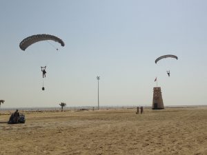 Hi-5 Army Ram Air Parachute Personnel product system for military special forces jumpers with glide modulation. Carries 485 lbs. Max deployment altitude 25,000 feet. Airborne Systems exhibiting at BIDEC in Bahrain showcasing products and demonstrating capabilities, i.e. desert landing.